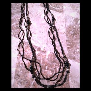 Elegant long beaded black and silver necklace.